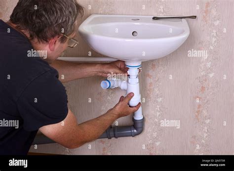 Plumber Fixes Leak In Drain Pipe By Replacing Siphon Stock Photo Alamy